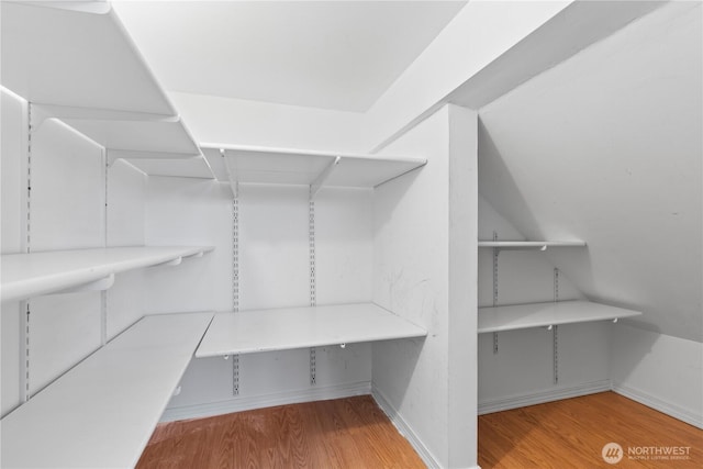 710 122nd Avenue Ct E, Edgewood, WA 98372 - walk in closet featuring wood finished floors