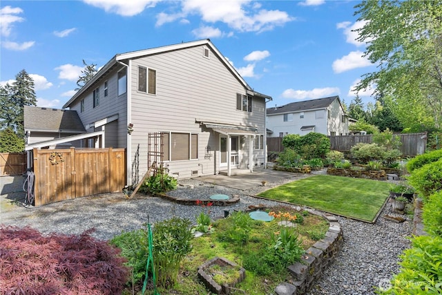 710 122nd Avenue Ct E, Edgewood, WA 98372 - rear view of house with a fenced backyard, a patio area, and a yard