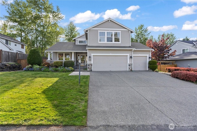 710 122nd Avenue Ct E, Edgewood, WA 98372 - view of front of house with a front lawn, fence, an attached garage, driveway, and a porch