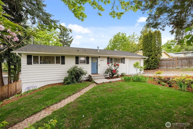 ranch-style home featuring fence, an attached garage, and a front lawn