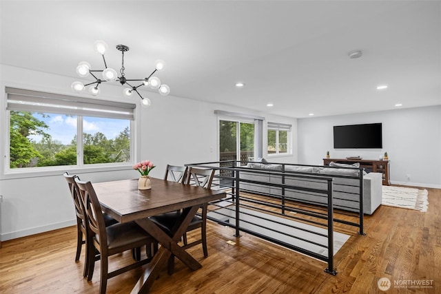 dining area featuring recessed lighting, baseboards, an inviting chandelier, and wood finished floors