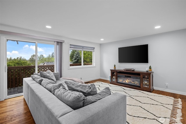 living room with baseboards, recessed lighting, and wood finished floors