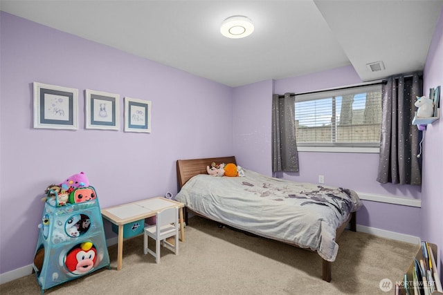 carpeted bedroom featuring baseboards and visible vents