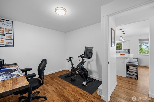 office space featuring baseboards and wood finished floors