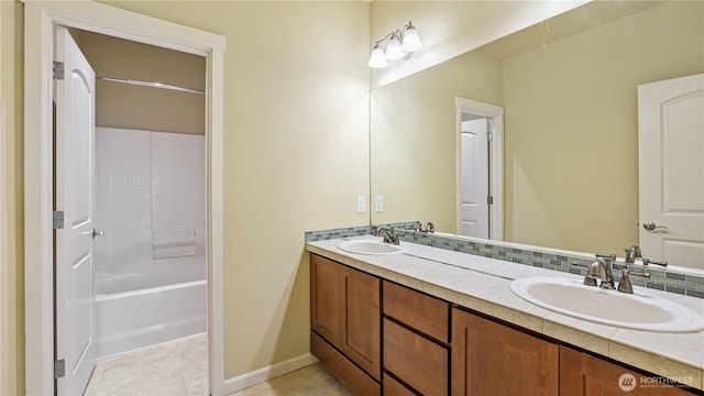 full bathroom with a sink, baseboards, and double vanity