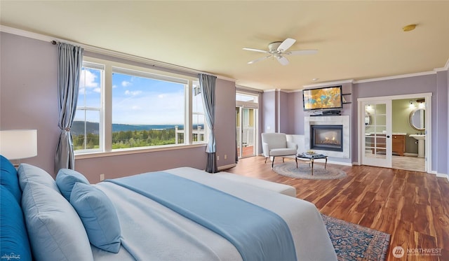 bedroom with crown molding and wood finished floors