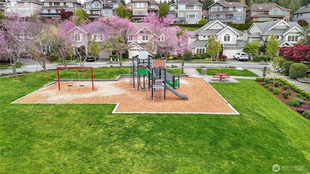 community jungle gym with a yard and a residential view