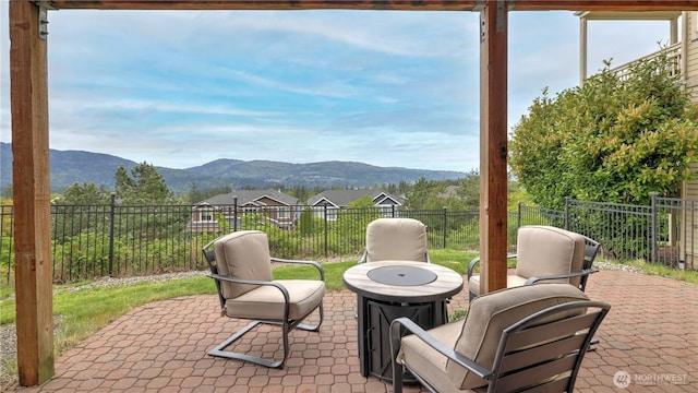 view of patio / terrace featuring a mountain view and fence