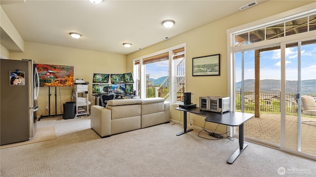 living room featuring carpet floors, visible vents, and a mountain view