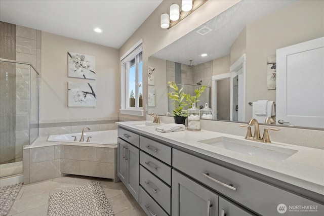 bathroom featuring tile patterned flooring, a shower stall, a sink, and a bath