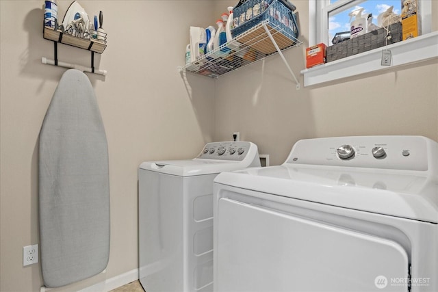 clothes washing area featuring laundry area and washer and clothes dryer