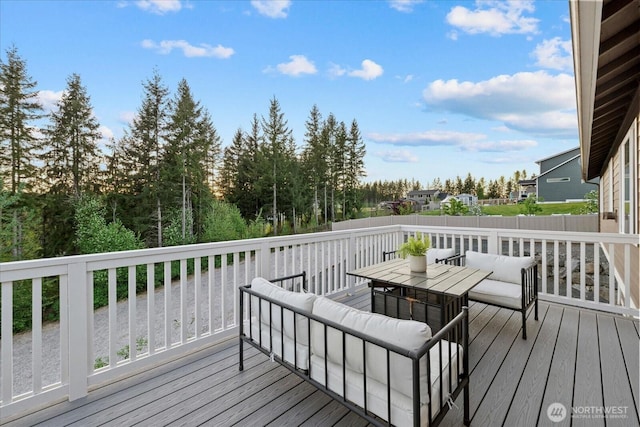 wooden terrace with outdoor dining area