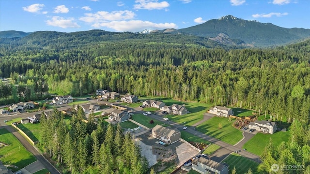 aerial view featuring a mountain view, a residential view, and a forest view