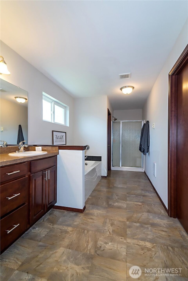 bathroom with visible vents, a bath, vanity, and a shower stall
