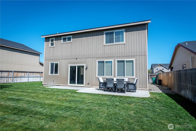 rear view of house with a yard, a patio, and a fenced backyard