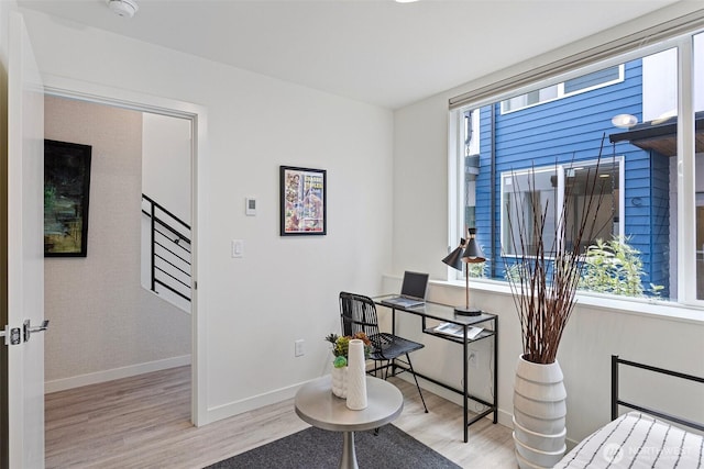 office area with baseboards and wood finished floors