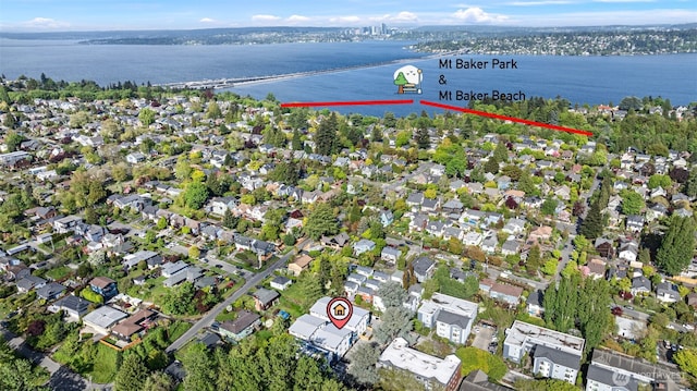 drone / aerial view featuring a residential view and a water view