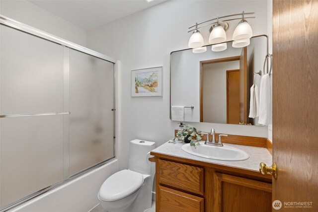 full bath with toilet, combined bath / shower with glass door, and vanity