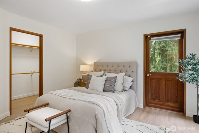 bedroom featuring baseboards and light wood-style flooring