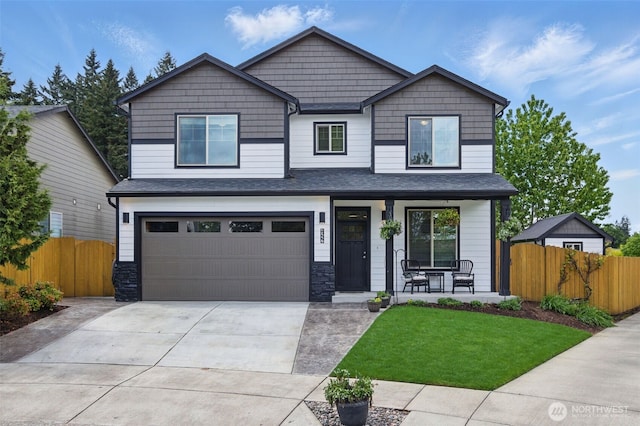 craftsman-style home featuring a porch, an attached garage, fence, and concrete driveway