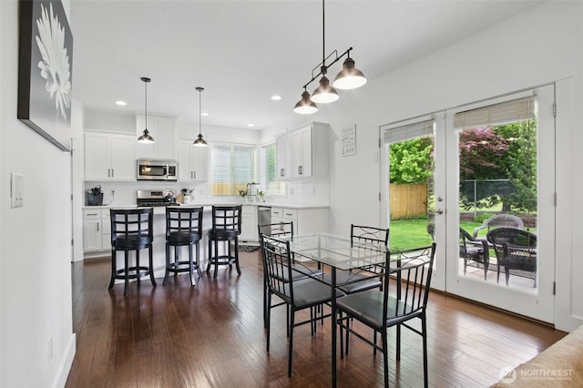 dining space featuring dark wood-style flooring, recessed lighting, and a wealth of natural light