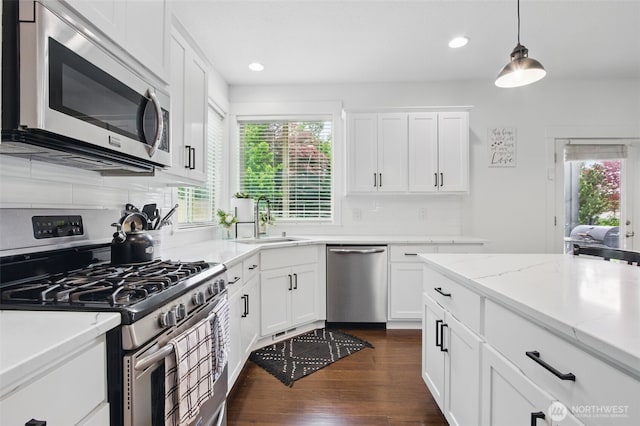 kitchen featuring a sink, stainless steel appliances, recessed lighting, tasteful backsplash, and dark wood-style floors