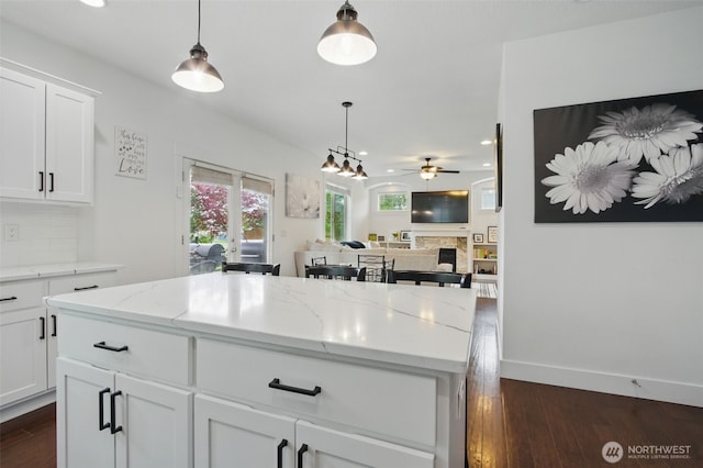 kitchen with dark wood finished floors, ceiling fan, pendant lighting, and recessed lighting
