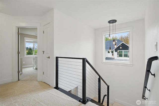 stairs with baseboards and carpet flooring