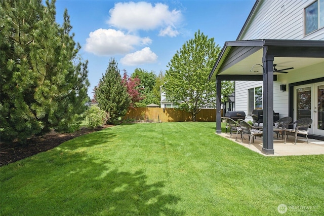 view of yard with french doors, a patio, fence, and a ceiling fan