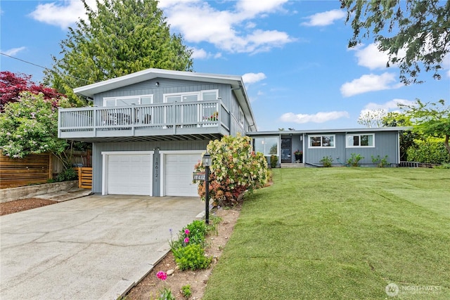 view of front facade featuring concrete driveway, a front yard, and a garage
