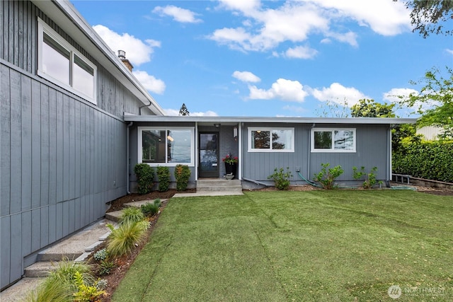 exterior space with a chimney and a front lawn