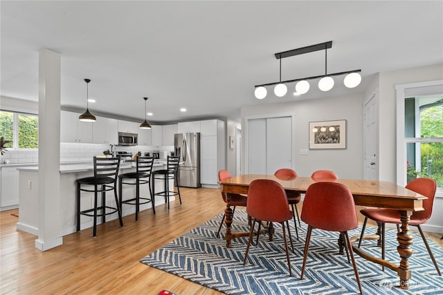 dining room featuring recessed lighting and light wood finished floors