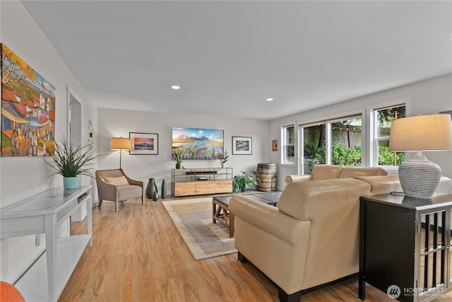 living area with recessed lighting and light wood-type flooring