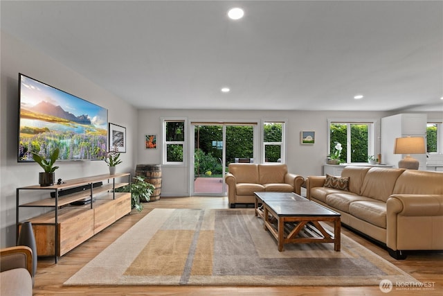 living room with light wood-type flooring and recessed lighting