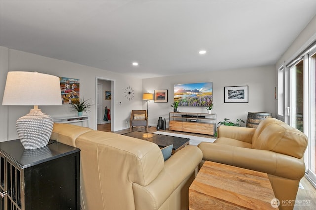 living room featuring baseboards, recessed lighting, and wood finished floors