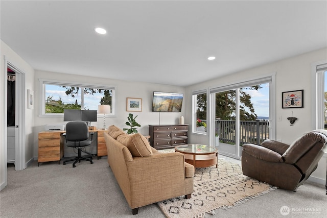 carpeted living area with recessed lighting and baseboards