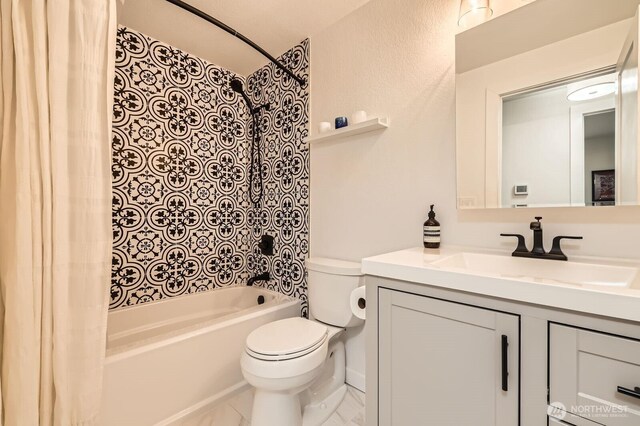 full bathroom featuring toilet, shower / bathtub combination with curtain, and vanity