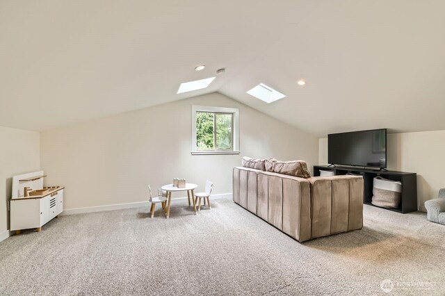 carpeted living area with recessed lighting, baseboards, and lofted ceiling with skylight