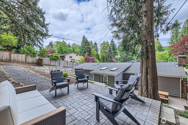 view of patio featuring an outdoor living space and a fenced backyard