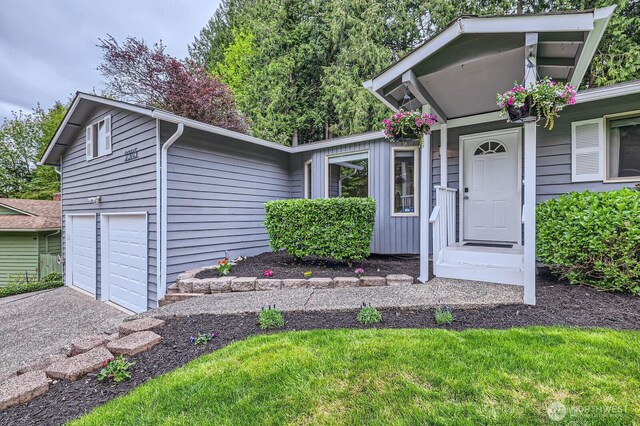 view of front of home with a garage and aphalt driveway