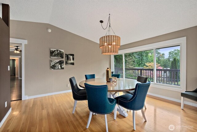15304 SE 296th St, Kent, WA 98042 - dining space featuring wood finished floors, lofted ceiling, baseboards, a textured ceiling, and ceiling fan with notable chandelier