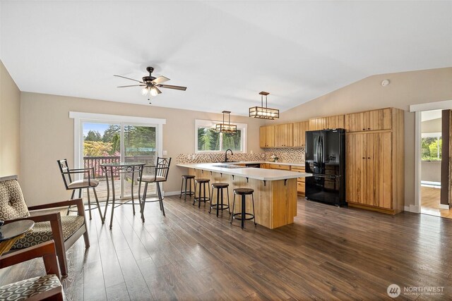 15304 SE 296th St, Kent, WA 98042 - kitchen featuring light countertops, freestanding refrigerator, a peninsula, dark wood-style floors, and a breakfast bar