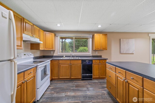 15304 SE 296th St, Kent, WA 98042 - kitchen featuring white appliances, dark countertops, under cabinet range hood, and a sink