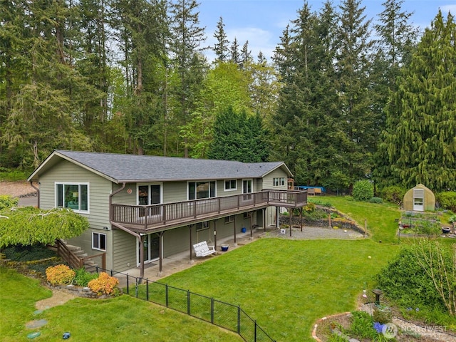 15304 SE 296th St, Kent, WA 98042 - back of property with a wooden deck, fence, a yard, a storage unit, and an outbuilding