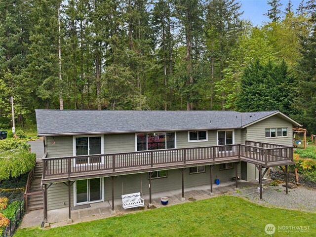 15304 SE 296th St, Kent, WA 98042 - back of property featuring a lawn, a patio area, roof with shingles, and a deck