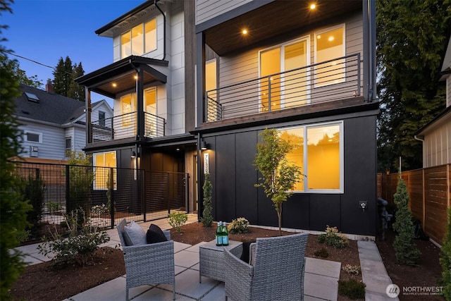 7356 21st Ave NW, Seattle, WA 98117 - back of property with fence, a balcony, and a patio area