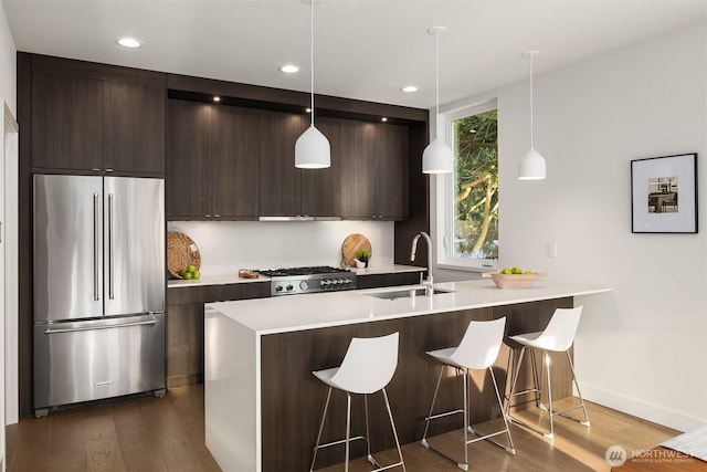 7356 21st Ave NW, Seattle, WA 98117 - kitchen featuring dark wood-style flooring, dark brown cabinetry, stainless steel fridge, and modern cabinets