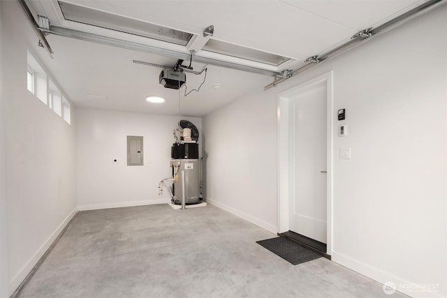 7356 21st Ave NW, Seattle, WA 98117 - garage featuring baseboards, a garage door opener, electric panel, and heat pump water heater