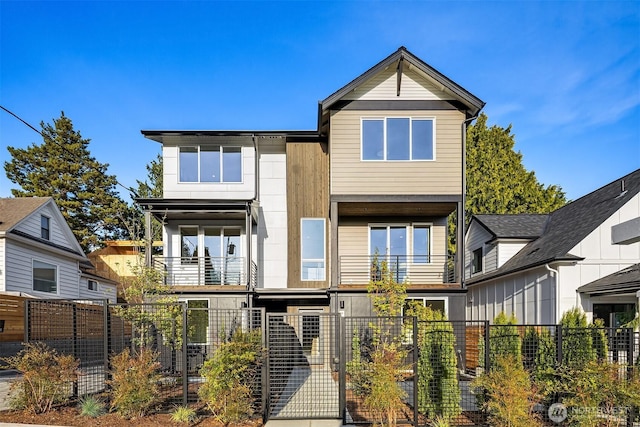 7356 21st Ave NW, Seattle, WA 98117 - view of front of home featuring a fenced front yard, a gate, and a balcony