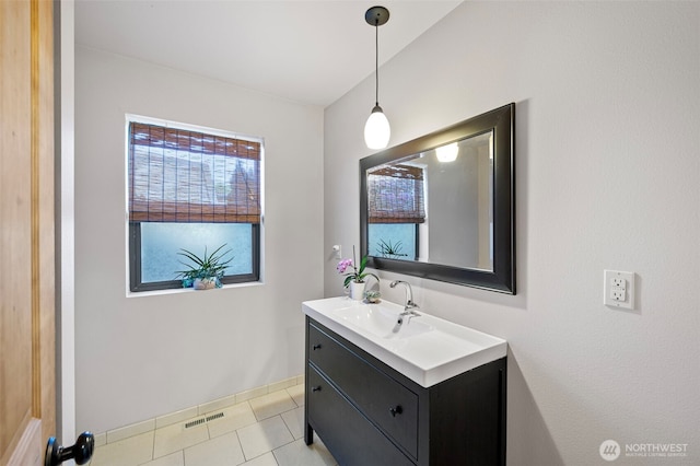 bathroom featuring vanity, baseboards, tile patterned floors, and visible vents